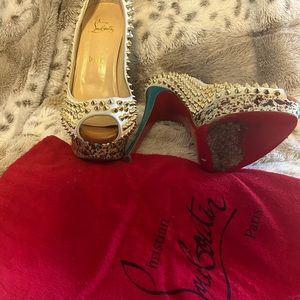 Christian Louboutin spiked peep toe.